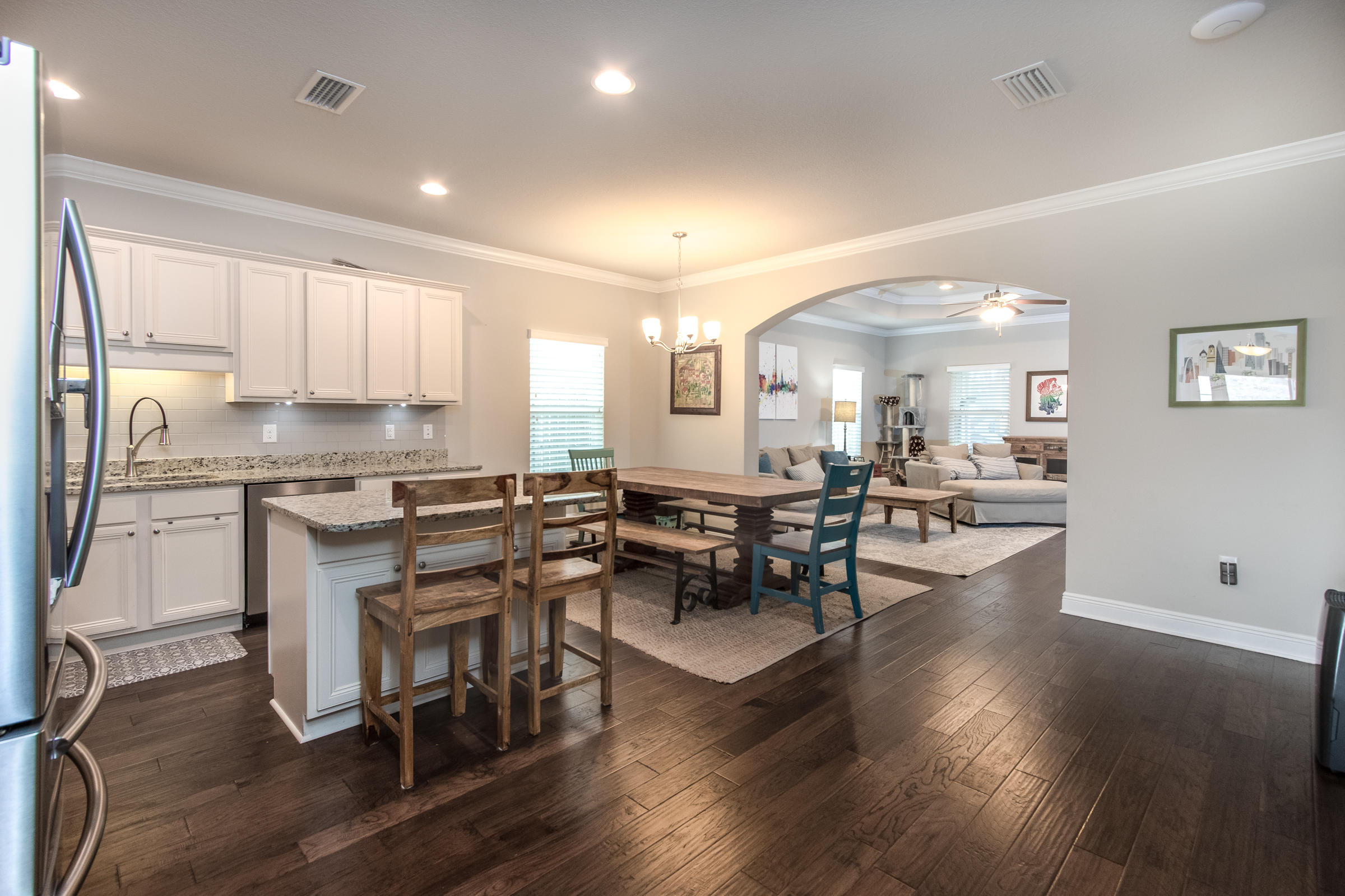 196 Pin Oak Loop Santa Rosa Beach, FL 32459 - Photo 7 of 34 a kitchen with a table chairs microwave and cabinets