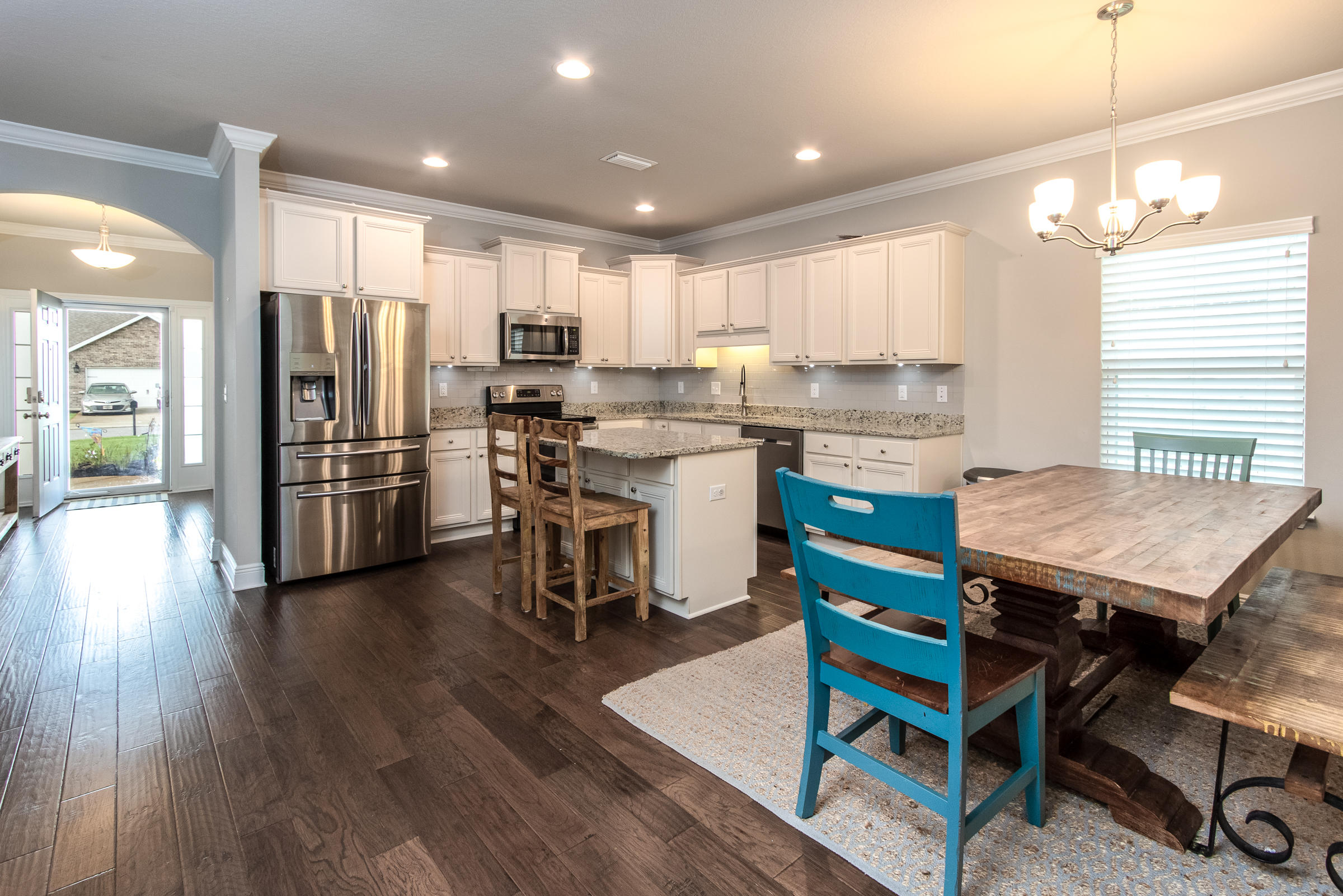 196 Pin Oak Loop Santa Rosa Beach, FL 32459 - Photo 8 of 34 a kitchen with a table chairs refrigerator and microwave
