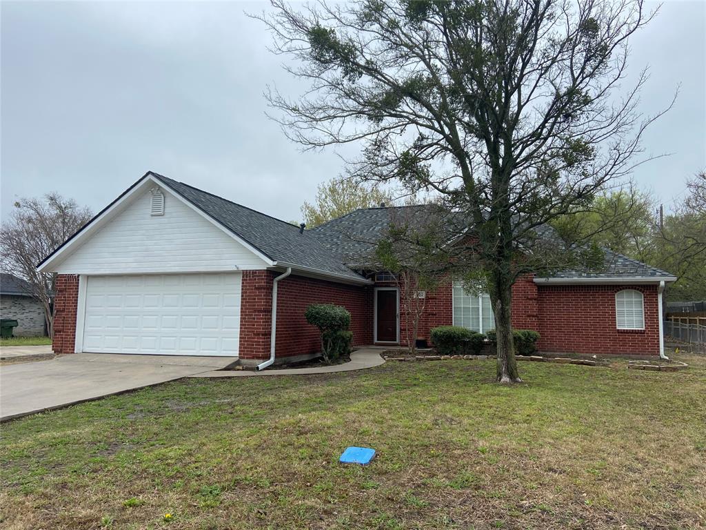 a front view of house with a garden