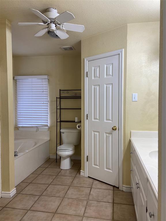 1102 North Main Street Leonard, TX 75452 - Photo 13 of 25 a bathroom with a toilet a sink and bathtub