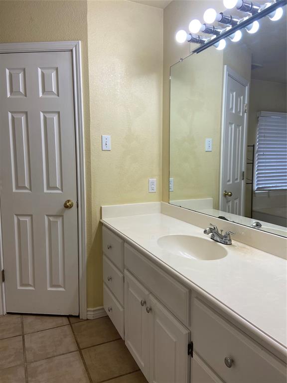 1102 North Main Street Leonard, TX 75452 - Photo 14 of 25 a bathroom with a double vanity sink and a mirror