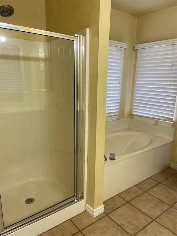 1102 North Main Street Leonard, TX 75452 - Photo 15 of 25 a bathroom with a bathtub and a shower