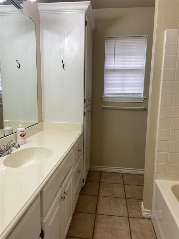 1102 North Main Street Leonard, TX 75452 - Photo 18 of 25 a bathroom with a sink a toilet and tub