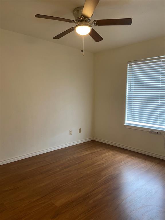 1102 North Main Street Leonard, TX 75452 - Photo 19 of 25 a view of an empty room with wooden floor and a window