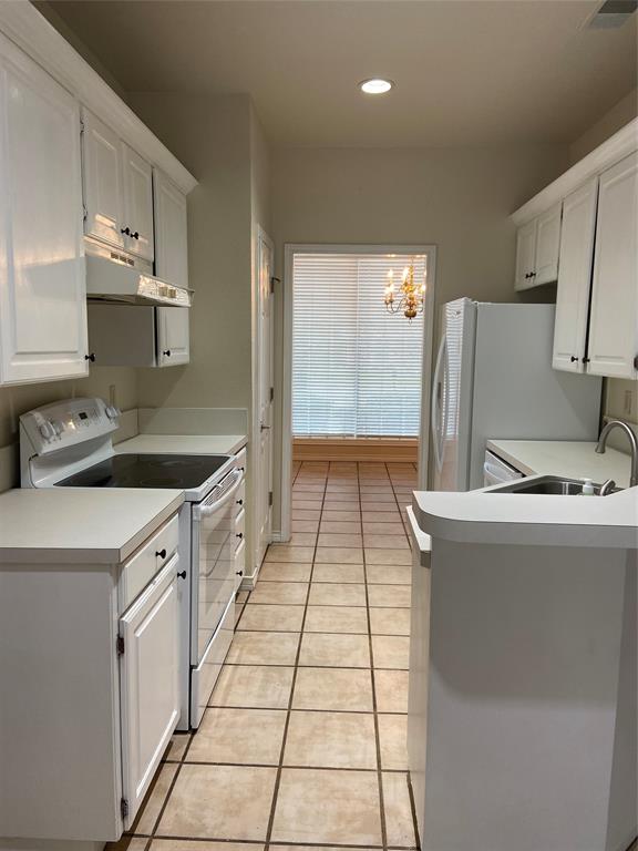 1102 North Main Street Leonard, TX 75452 - Photo 7 of 25 a kitchen with a sink a stove and refrigerator