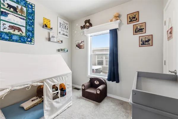 a room with furniture and baby crib