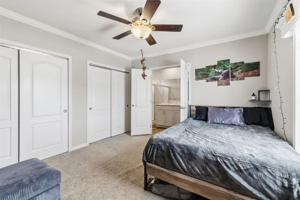 a bedroom with a large bed and a chandelier