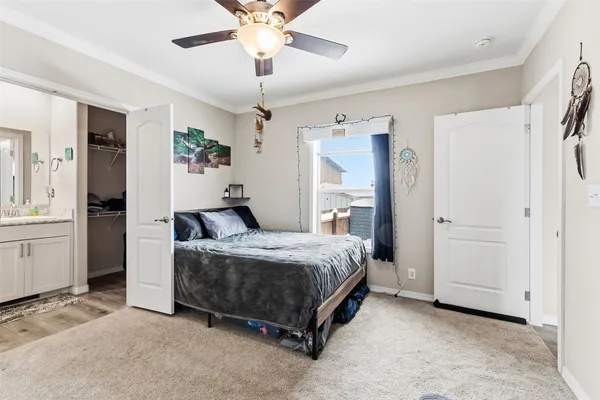 a spacious bedroom with a bed and a chandelier