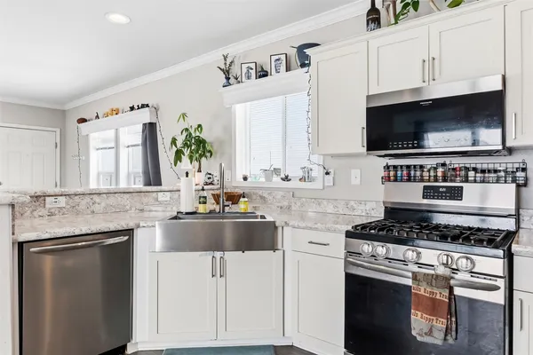 a kitchen with granite countertop a stove and a sink