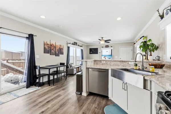 a kitchen with granite countertop a sink stove and cabinets