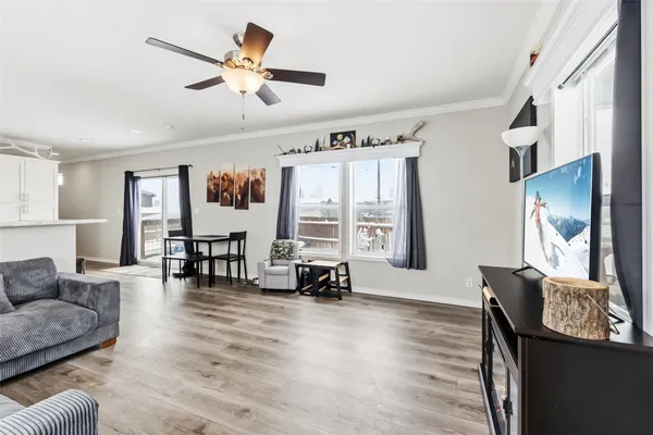 a living room with furniture and wooden floor