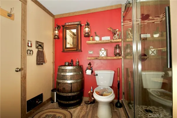 a bathroom with a toilet and a shower