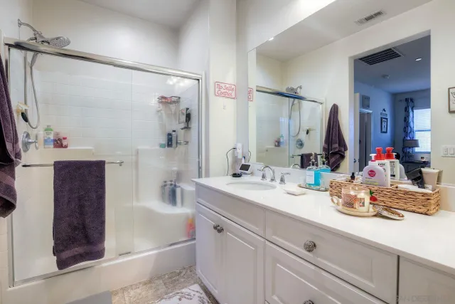 a bathroom with a sink double vanity and a mirror