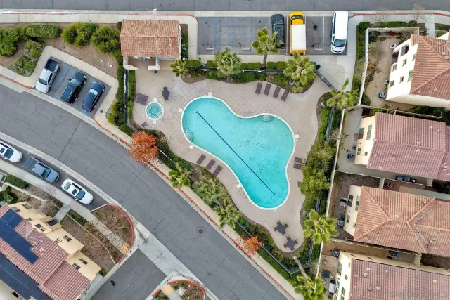 an aerial view of an buildings and swimming pool