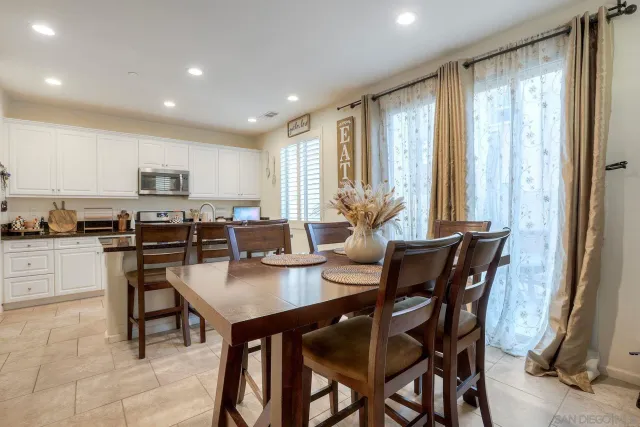 a dining room with furniture and window