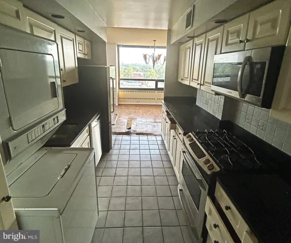 a view of a room with an empty space and window