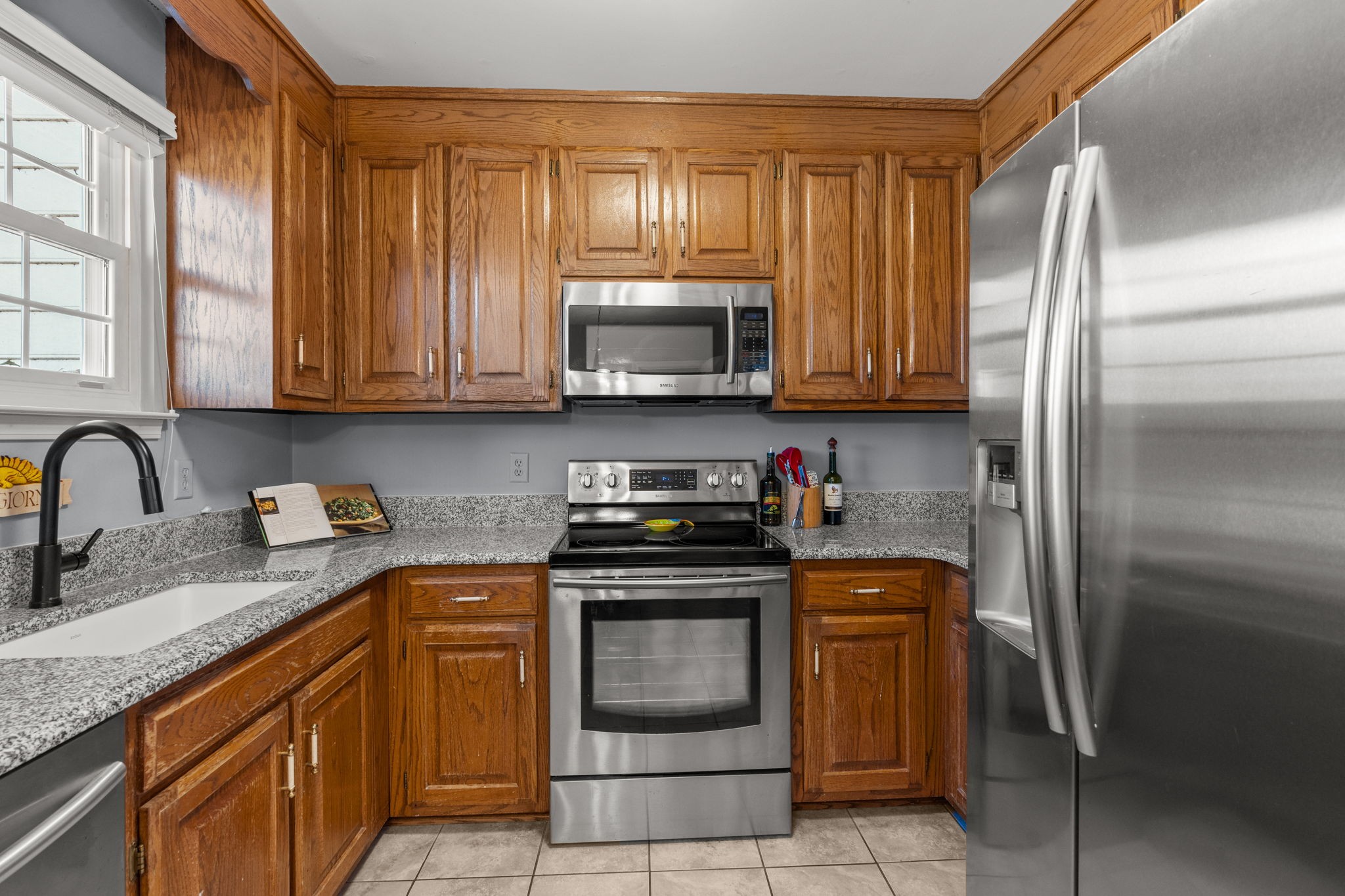 541 General George Patton Road Nashville, TN 37221 - Photo 5 of 23 a kitchen with stainless steel appliances granite countertop a stove a refrigerator and a sink