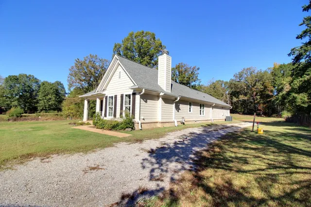 a view of a livingroom with wooden floor and a fireplace