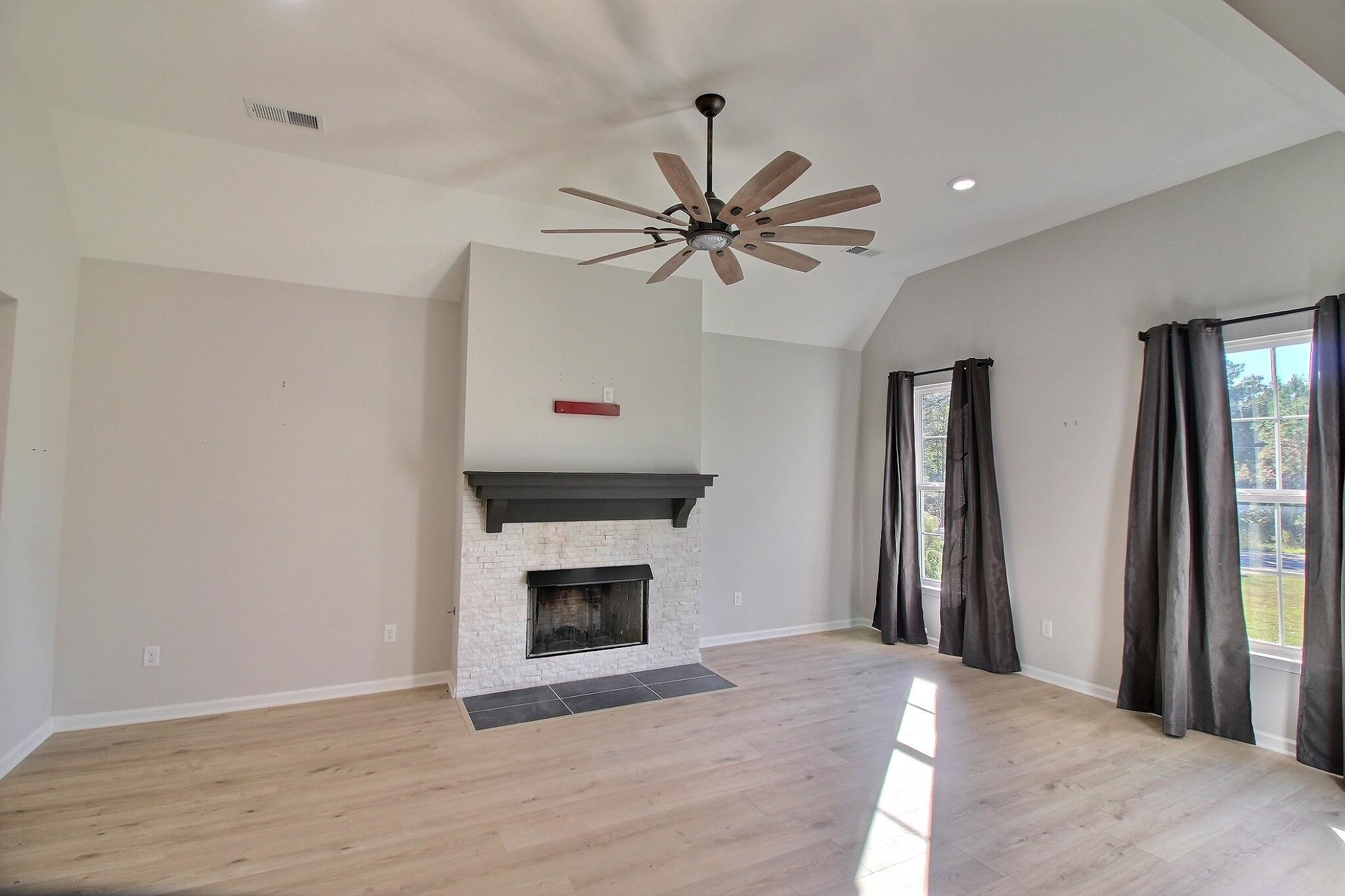 3290 Raleigh Lagrange Drive Rossville, TN 38066 - Photo 8 of 25 a view of a livingroom with a fireplace and a ceiling fan