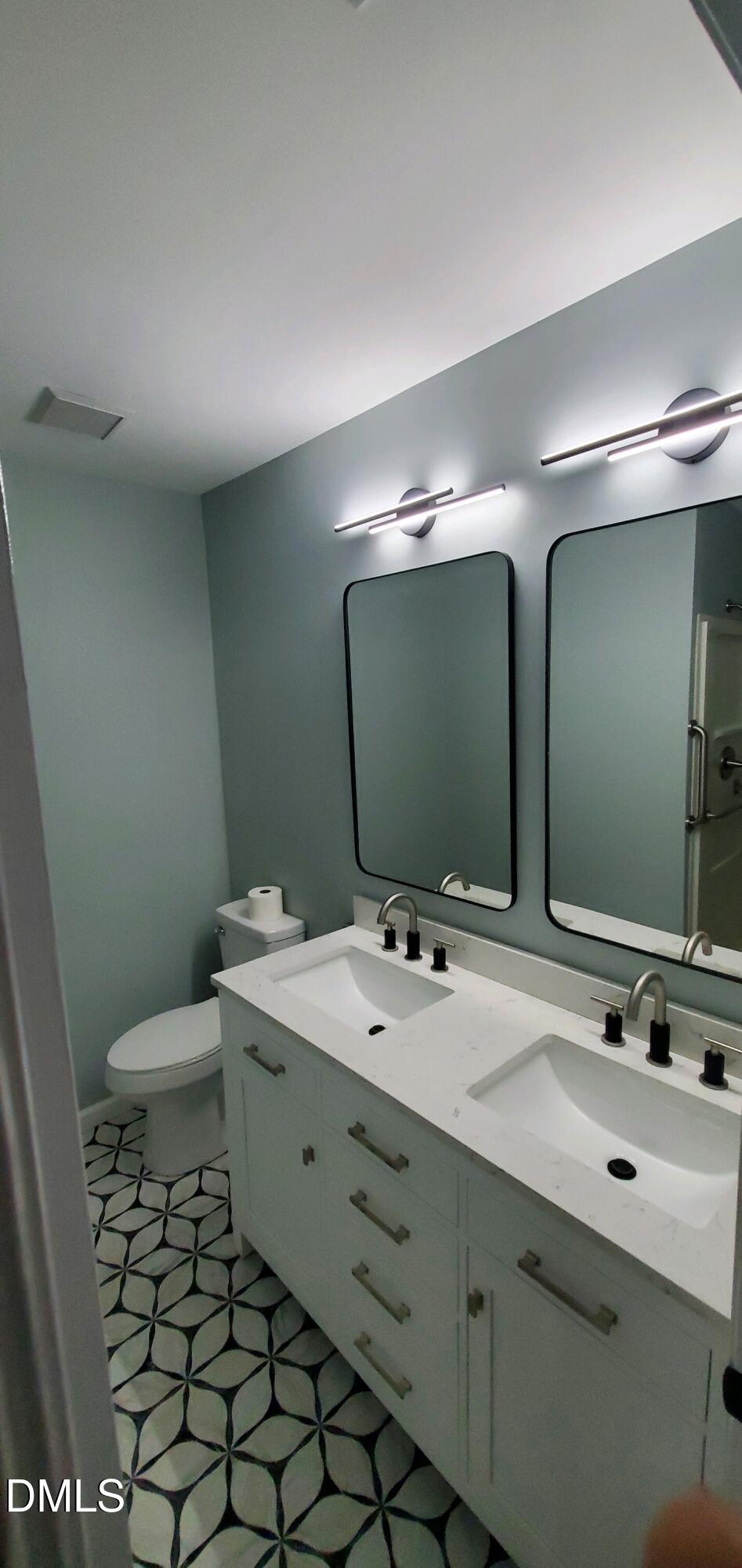 20 Sparger Springs Lane Durham, NC 27705 - Photo 11 of 11 a bathroom with a double vanity sink mirror and toilet