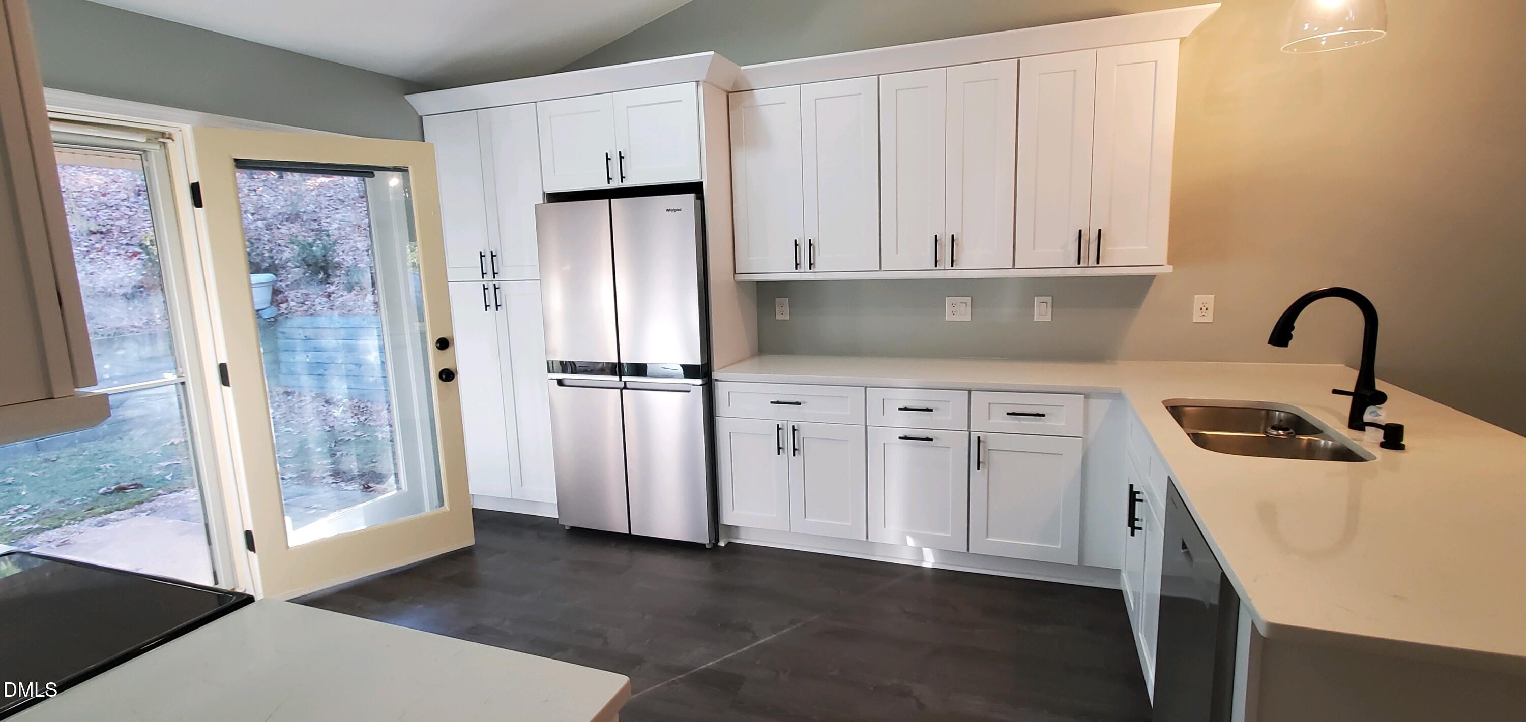 20 Sparger Springs Lane Durham, NC 27705 - Photo 7 of 11 a kitchen with stainless steel appliances a refrigerator sink and cabinets