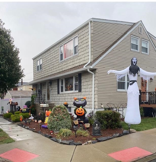 a front view of a house with sitting area