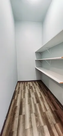 a view of a room with wooden floor