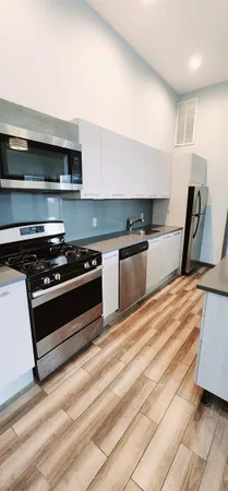 a kitchen with granite countertop a stove and a sink