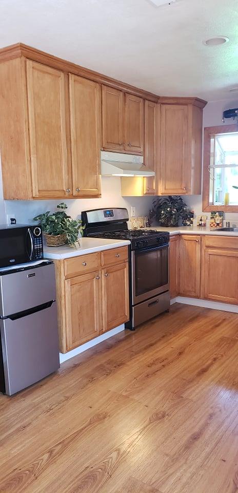 1659 Center Road Novato, CA 94947 - Photo 6 of 17 a kitchen with stainless steel appliances granite countertop a stove a sink and a microwave