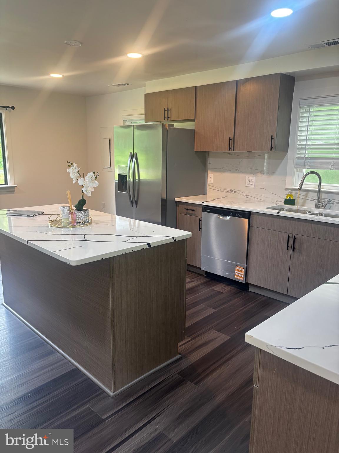 9250 Slidell La Plata, MD 20646 - Photo 11 of 43 a kitchen with kitchen island granite countertop a sink cabinets and wooden floor
