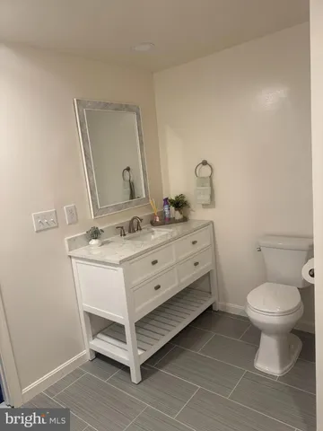 a bathroom with a sink toilet and mirror