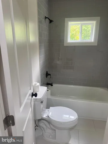 a bathroom with a toilet and a bathtub