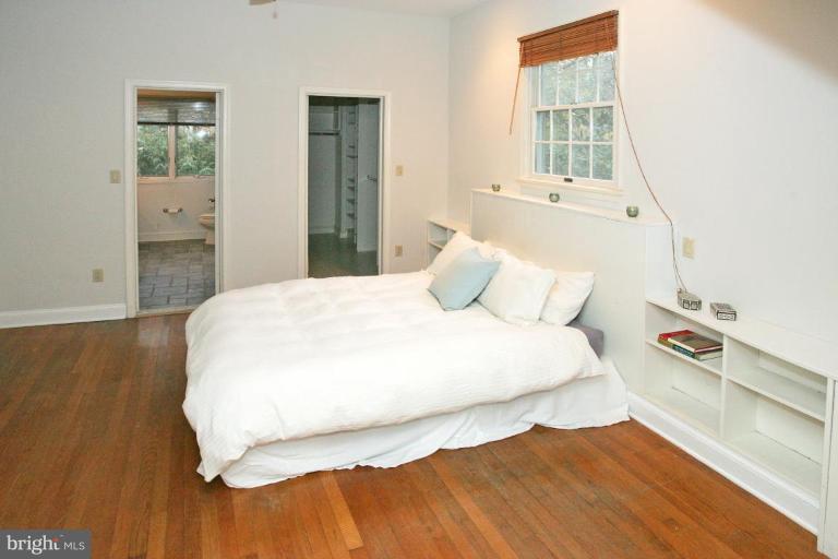 8703 Ridge Road Bethesda, MD 20817 - Photo 7 of 8 a large bed sitting in a bedroom next to a window
