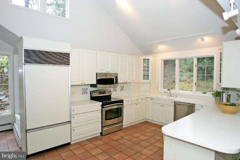 8703 Ridge Road Bethesda, MD 20817 - Photo 8 of 8 a kitchen with a stove a sink and a refrigerator