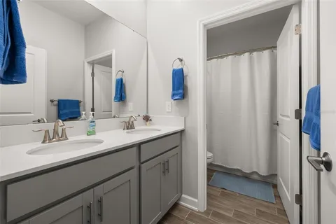 a bedroom with a bed dresser and a window