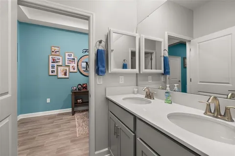 a bathroom with a granite countertop sink toilet and mirror