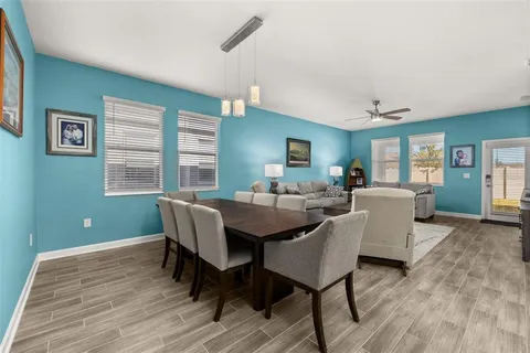 a kitchen with a sink a stove a refrigerator and white cabinets