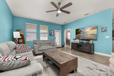 a spacious bedroom with a bed and a dresser next to a window