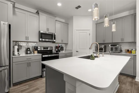 a bathroom with a granite countertop sink a toilet a mirror and shower