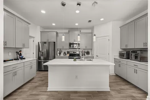 an aerial view of residential houses with outdoor space and lake view