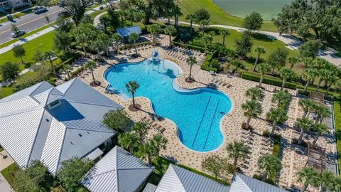 an aerial view of a house with a swimming pool yard and outdoor seating