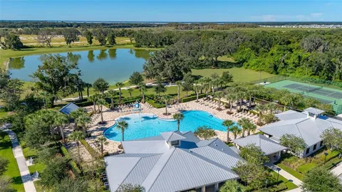 an aerial view of a residential houses with outdoor space and street view