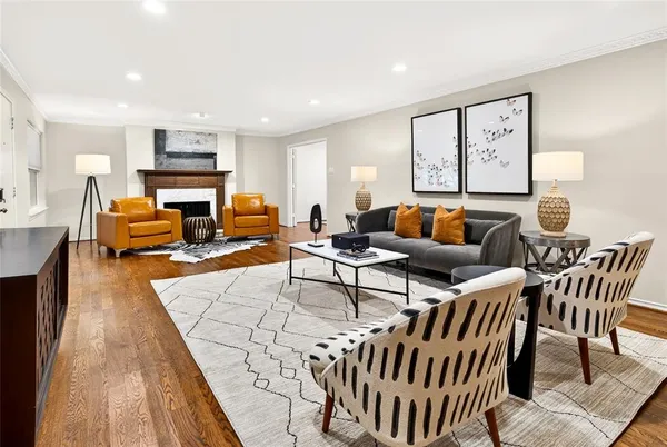 a living room with furniture wooden floor and a large window