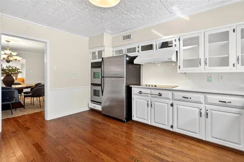 a kitchen with stainless steel appliances granite countertop a refrigerator and a stove