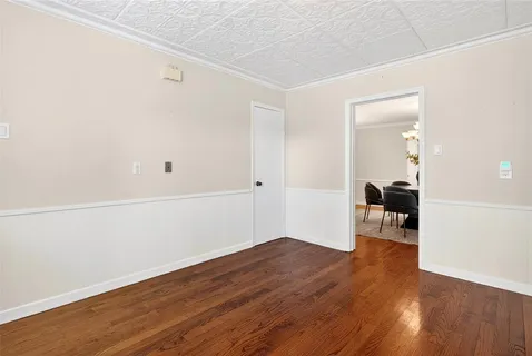 a view of a room with wooden floor and bench