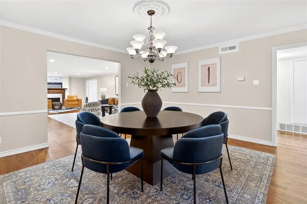 a dining room with furniture and chandelier