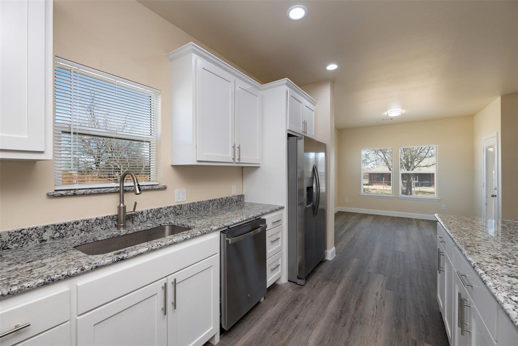200 South Oak Street Venus, TX 76084 - Photo 13 of 36 a kitchen with stainless steel appliances granite countertop a sink stove and refrigerator