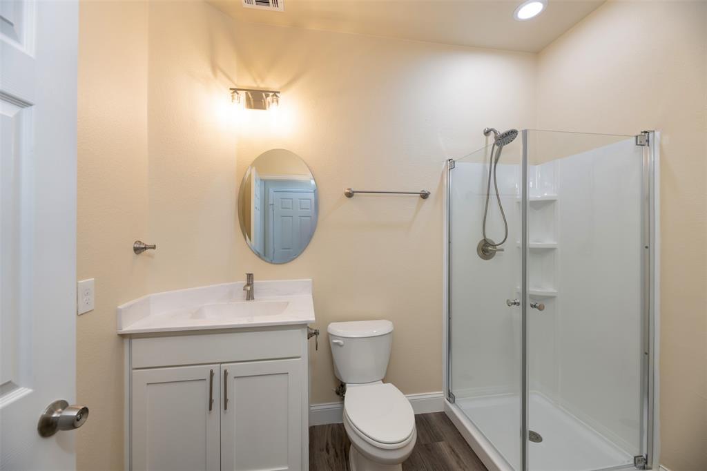 200 South Oak Street Venus, TX 76084 - Photo 23 of 36 a bathroom with a toilet sink and shower