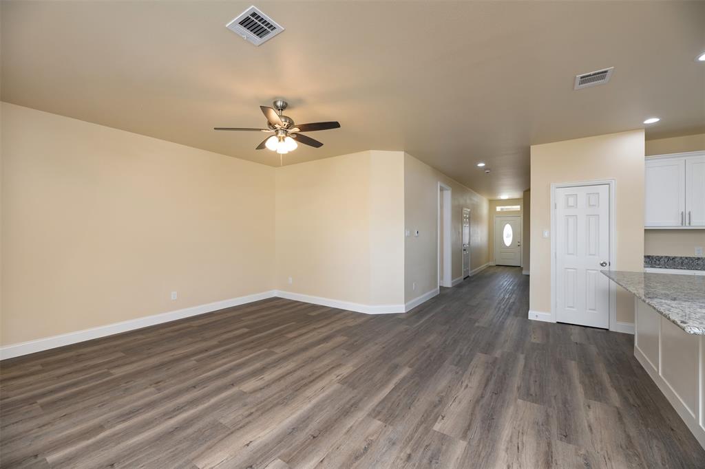 200 South Oak Street Venus, TX 76084 - Photo 9 of 36 a view of a kitchen with a dishwasher and wooden floor
