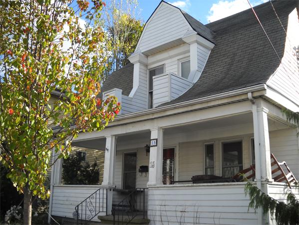 15 County Road Everett, MA 02149 - Photo 1 of 19 a view of a white house with large windows and a tree